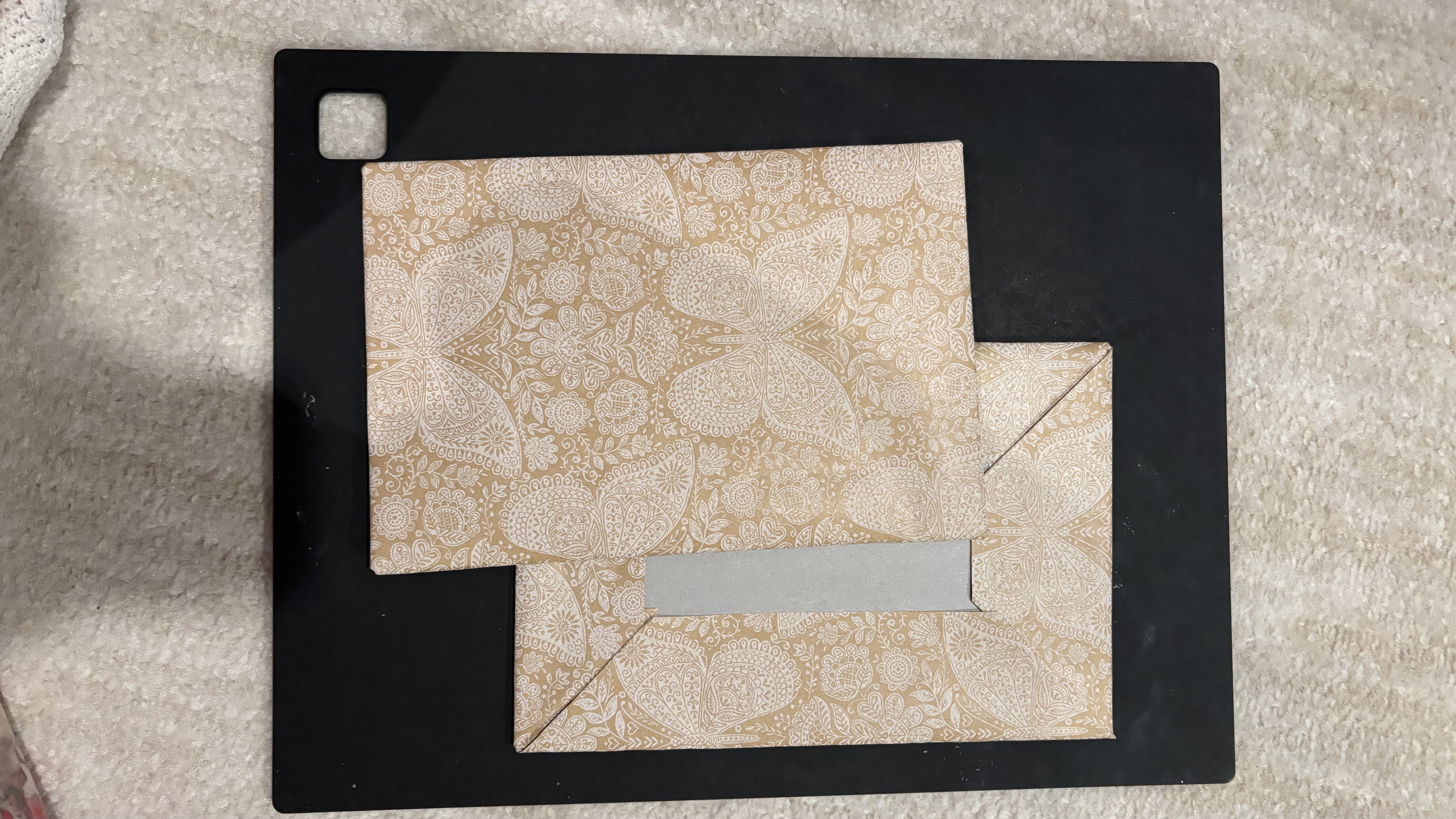Completed handmade book covers wrapped in decorative paper