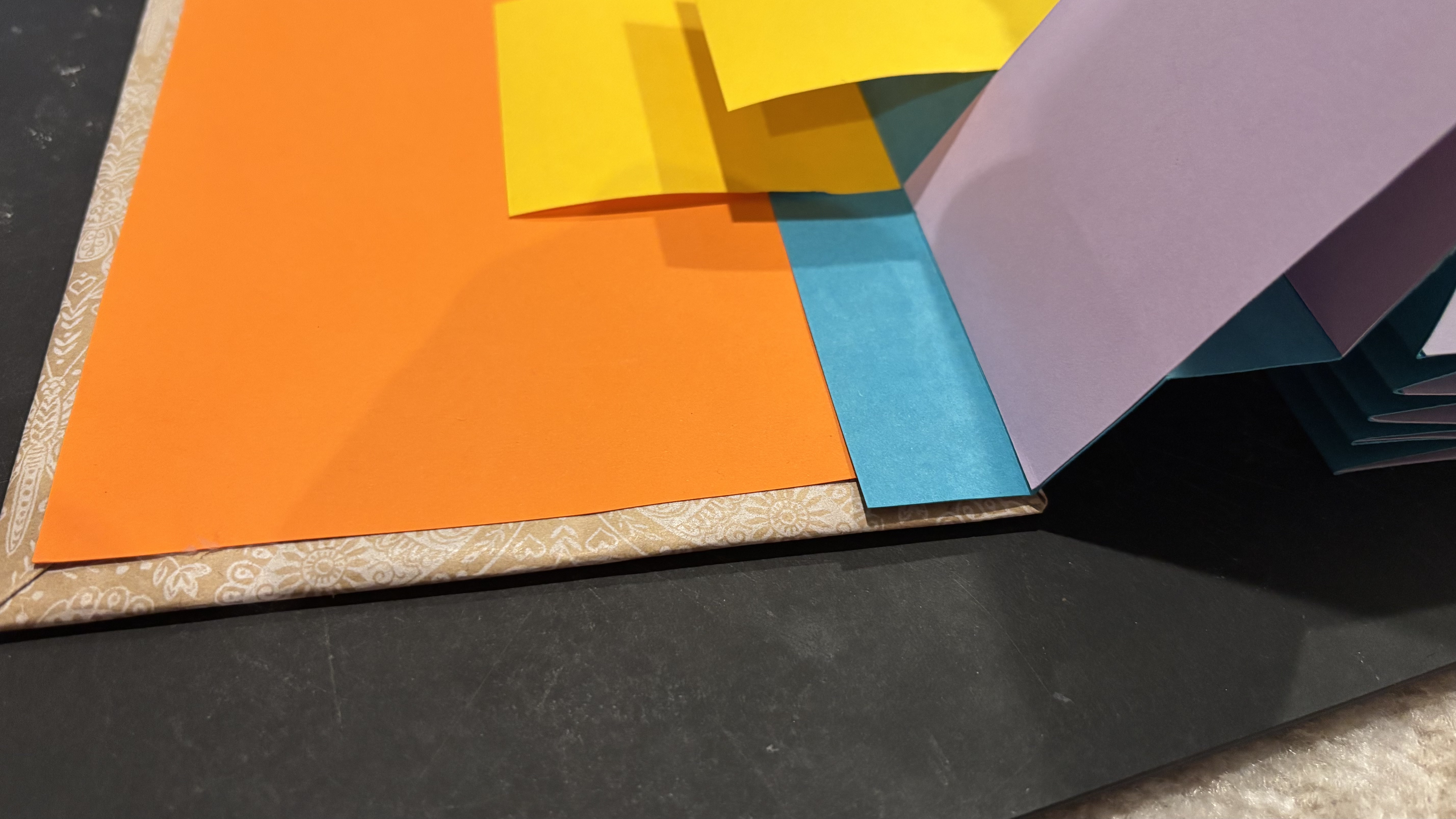 Attaching the accordion spine to the inside of the book cover